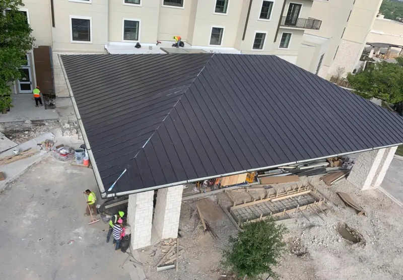 Metal roofing installation team working on a commercial building in Brandon